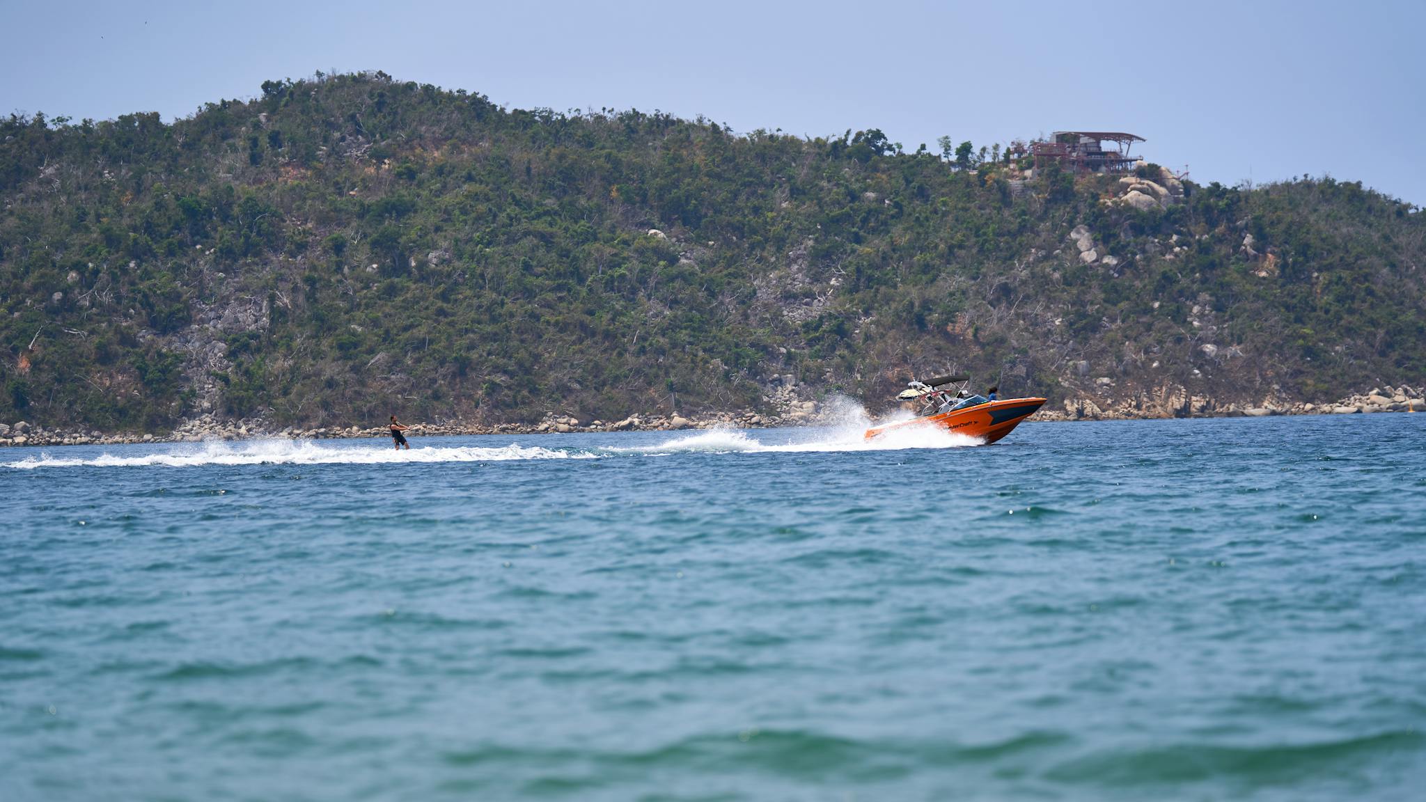 Exciting jet ski ride across clear ocean with scenic island backdrop, capturing summer fun and adventure.