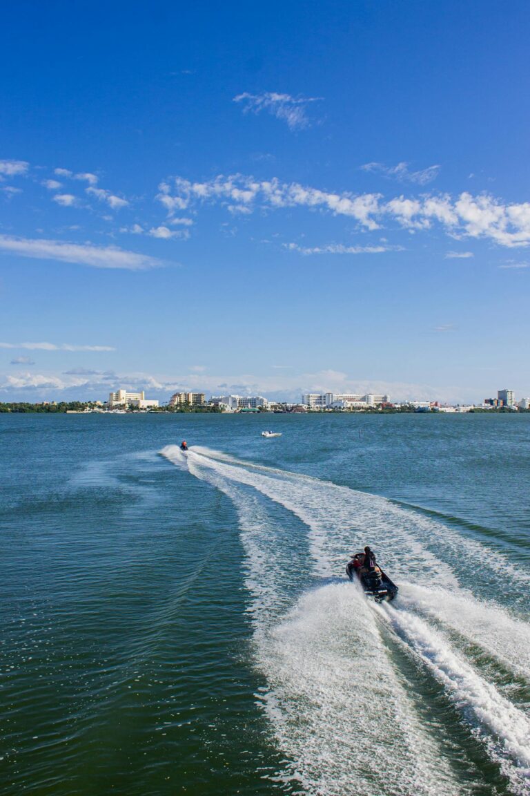 Jet ski enthusiasts enjoy the thrill of water sports on Cancun's clear blue waters.