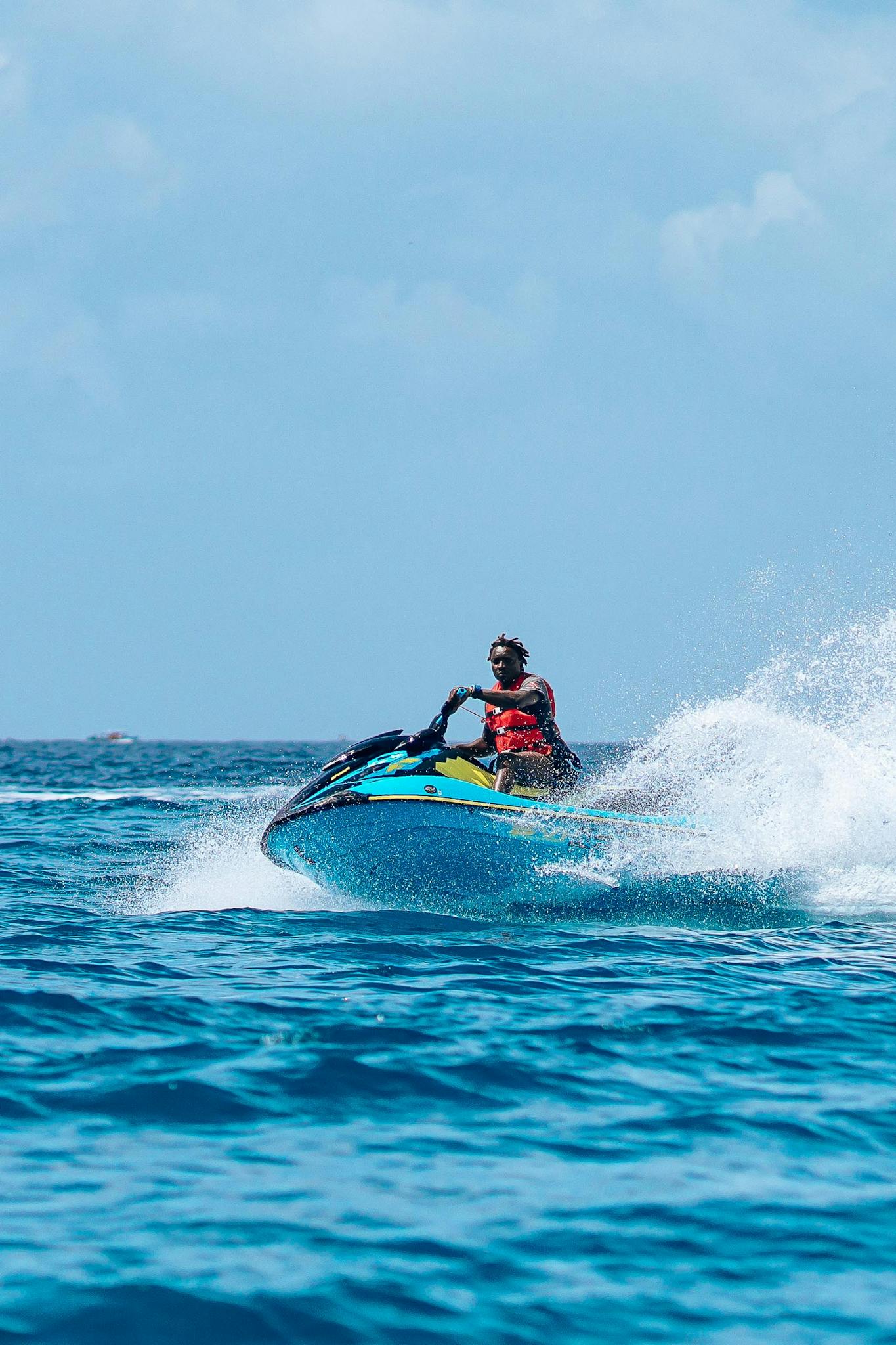 Thrilling jet skiing experience on the open sea, capturing the speed and excitement of water sports.